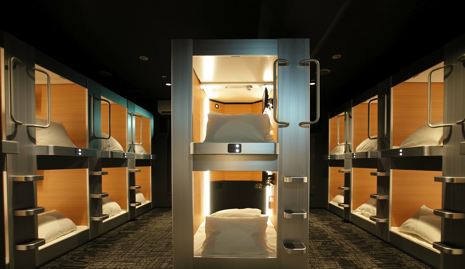 Rows of capsules stacked in two tiers under a low ceiling